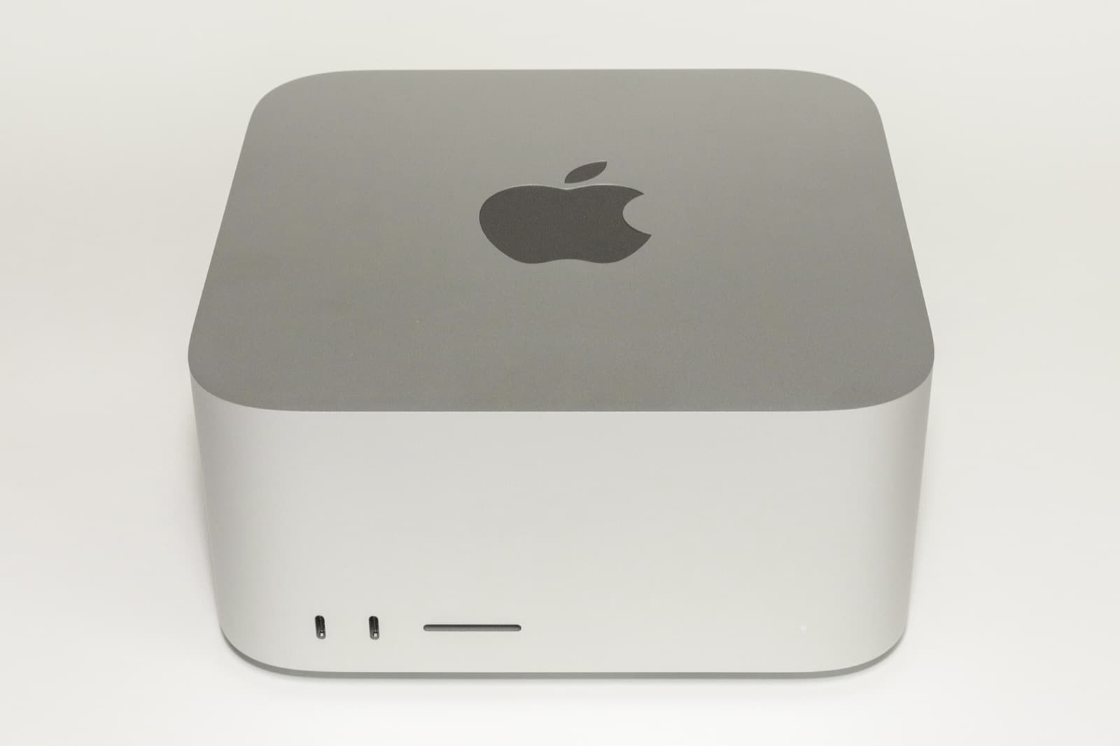 Front view of a compact silver Mac Studio desktop computer.